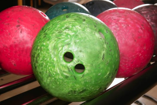 Bowling balls red green closeup row detail