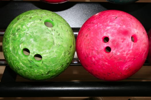 Bowling balls red green closeup row detail