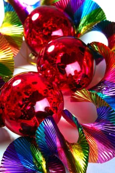 Christmas balls red shiny on colorful party background