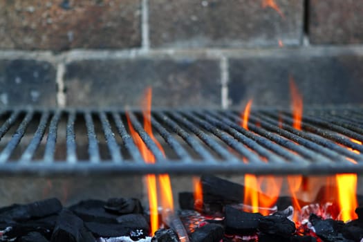 Bar b cue barbecue fire BBQ coal fire iron grill brick wall
