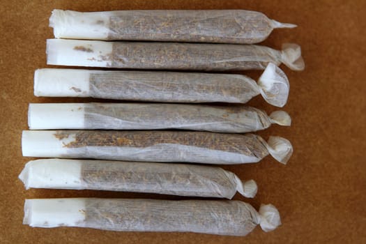 joint cigarettes hand rolled in row tobacco closeup
