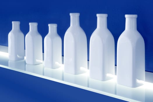 white bottles in row blue background glowing shelf decoration
