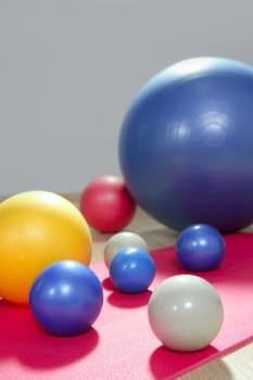 balls stability and toning pilates sport gym on red yoga mat
