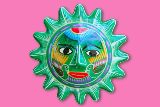 Mexican indian sun handcraft ceramic isolated in pink background