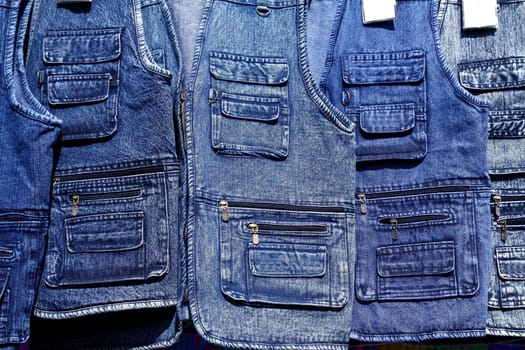 Denim blue jeans vest rows in a retail fashion shop