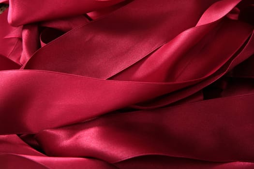 Red satin ribbons in a messy mess texture background