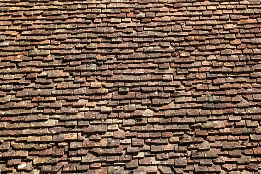 square roof tiles plain clay pattern weathered aged Pyrenees architecture detail