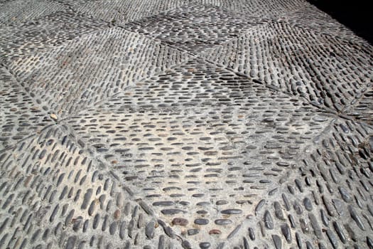 rolling stones mosaic in medieval soil floor in Spain Aragon