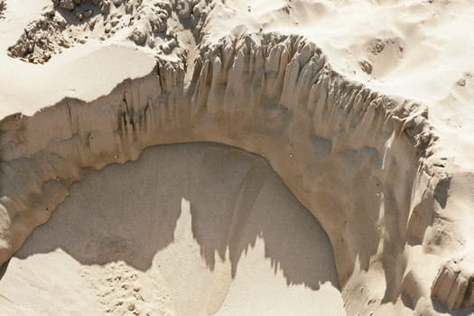 landslide hole detail beach sand aerial view half circle