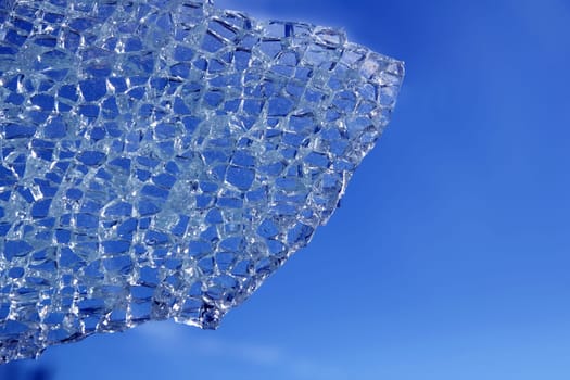 broken glass cracked over blue sky background