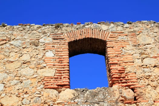 brick segmental arch in ancient masonry stone wall from Spain