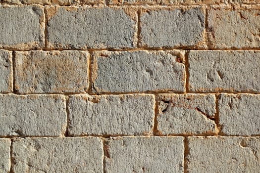 Castle masonry wall carved stone rows pattern ancient texture in Spain