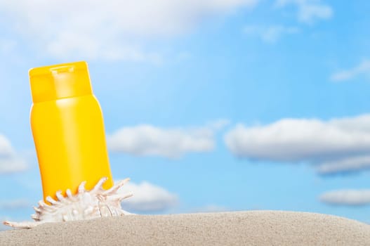 Tube with sun protection on beach and blue sky in background