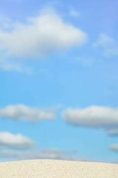 beach and blue sky in background. Focus on the sand