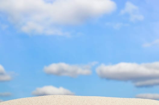 beach and blue sky in background. Focus on the sand