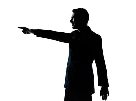one caucasian business man poiting portrait silhouette in studio isolated on white background