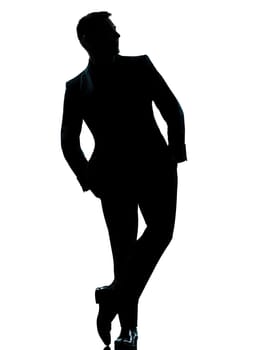one caucasian business man silhouette standing Full length hands in pocket in studio isolated on white background