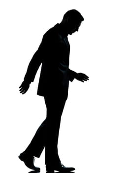one caucasian business man walking silhouette Full length in studio isolated on white background