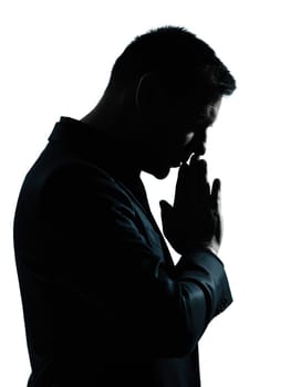 one caucasian business man thinking praying  portrait silhouette in studio isolated on white background