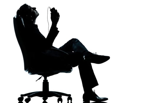 one caucasian business man listening music relaxing silhouette Full length in studio isolated on white background