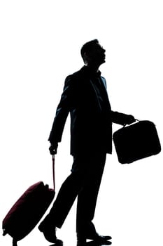 one caucasian business traveler man walking with suitcase lost looking up  full length silhouette in studio isolated white background