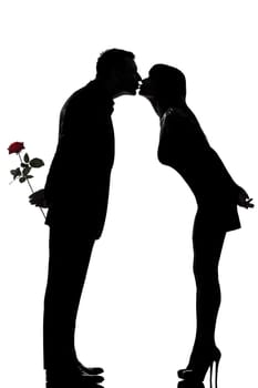 one caucasian couple man and woman kissing in studio silhouette isolated on white background