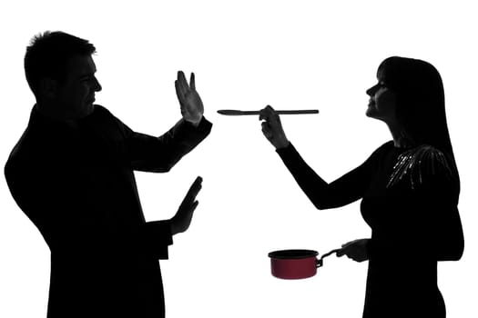 one caucasian couple man and woman tasting cooking sauce pan in studio silhouette isolated on white background