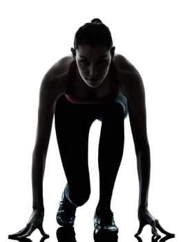 one caucasian woman sprinter on starting block in silhouette studio isolated on white background