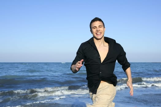 Man running happy on the blue summer beach, sunny summer