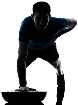 one caucasian man exercising push ups on bosu workout fitness in silhouette studio  isolated on white background