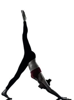 one caucasian woman exercising yoga  Adho Mukha Svanasana in silhouette studio isolated  on white background