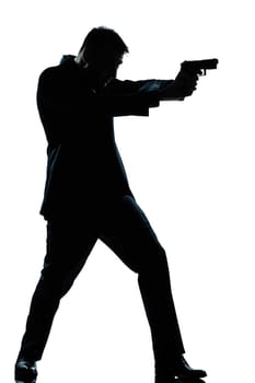 one caucasian spy criminal policeman detective man aiming shooting gun  full length silhouette in studio isolated white background