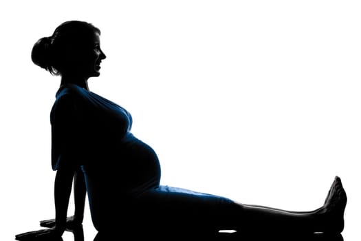 beautiful caucasian pregnant woman in silhouette on studio isolated white background