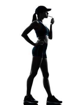one caucasian woman runner jogger smoking in silhouette studio isolated on white background