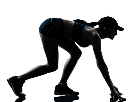 one caucasian woman runner jogger  on the starting block in silhouette studio isolated on white background