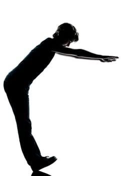 one caucasian young teenager silhouette boy or girl standing balancing on heels  full length in studio cut out isolated on white background