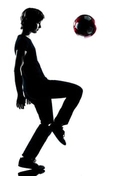 one caucasian young teenager silhouette boy girl  juggling soccer football full length in studio cut out isolated on white background