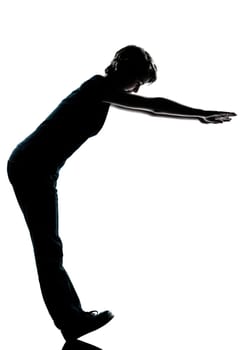 one caucasian young teenager silhouette boy or girl standing balancing on heels  full length in studio cut out isolated on white background