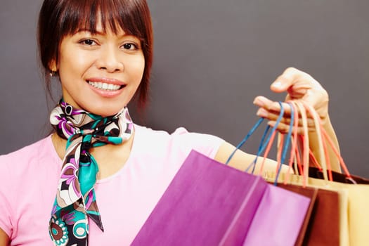 Happy female with bags looking at camera with smile