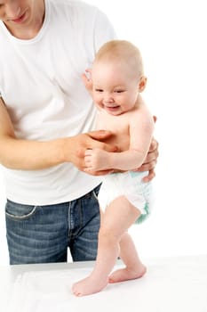 Young father teaching his baby how to walk