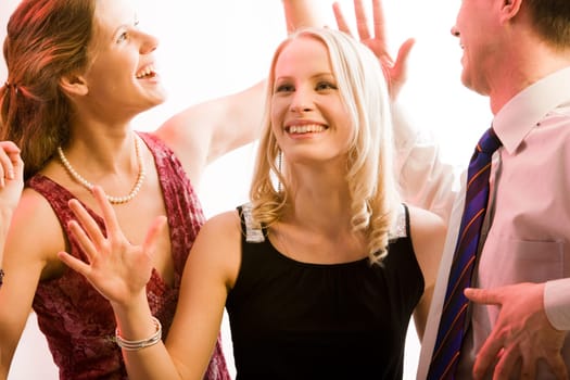 Portrait of three people funning and dancing