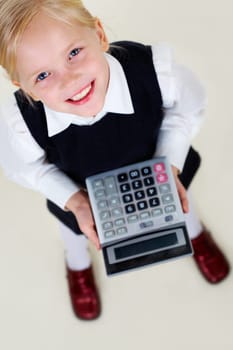 Portrait of happy girl with calculator looking at camera