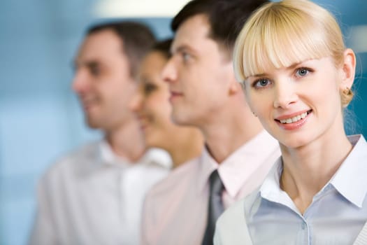 Image of business group standing in line with pretty female in front