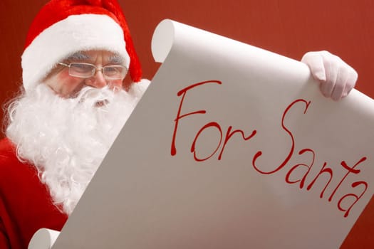 Portrait of Santa Claus reading big letter attentively