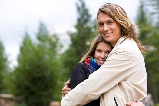 Portrait of affectionate couple embracing outdoors
