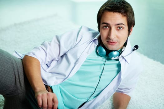 Image of serious man in casual clothes with headphones