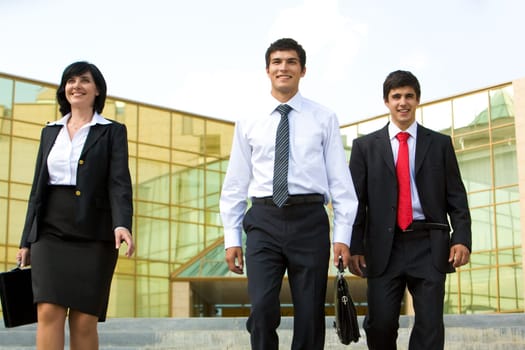 Portrait of three business people leaving their work