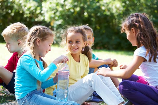 Portrait of happy friends chatting with each other in park