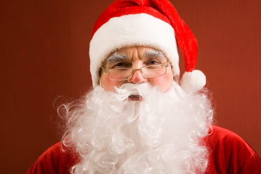 Photo of happy Santa Claus in eyeglasses looking at camera