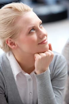 Image of young female looking aside while listening to somebody